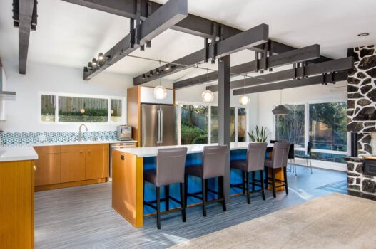 College Hill Mid Century Kitchen Eugene Mid-Century influenced kitchen remodel with open plan, wood beams, geometric patterned tile backsplash, and bar counter.