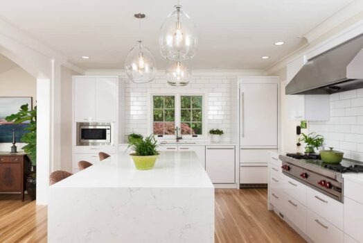 Council Crest Kitchen Portland Modern contemporary kitchen with white subway tile walls, white quartz waterfall island, white cabinets, and gas cooktop stove.
