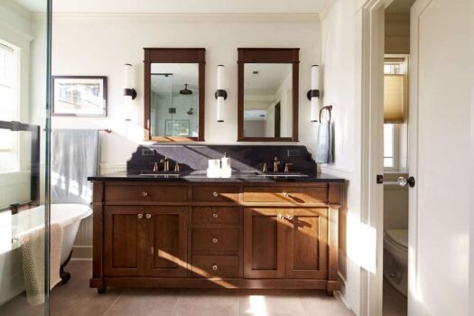 Modern traditional bathroom design with dark wood cabinetry