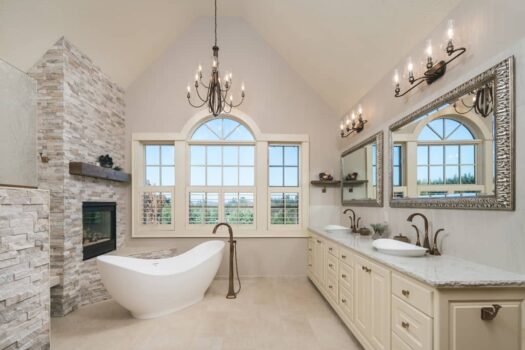 Meridian Way Master Bath Portland Bathroom with fireplace and mantle, freestanding tub, floormount tub filler, live edge countertop, and two vessel sinks.