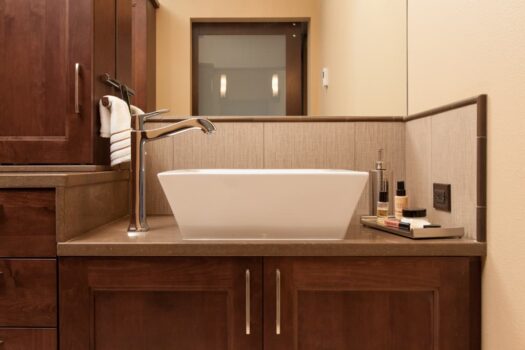 Mt Park Bathroom Portland 012 Accesabile design Bathroom vanity with vessel sink, side faucet, quartz countertops, and wood under sink cabinets.