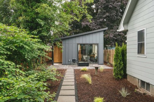SE Portland Accessory Dwelling Unit ADU 002 Modern contemporary style accessory dwelling unit with grey siding, shed roof, sliding glass door, and patio area.