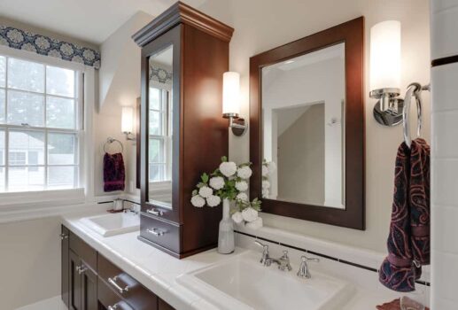 Southwest Portland Vintage Bathroom Traditional style bathroom remodel with white tile countertop, dual sinks, wood cabinets, and mirrored wall cabinet.