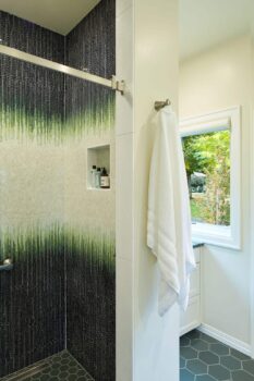 green mosaic shower tile in a garden inspired bathroom design