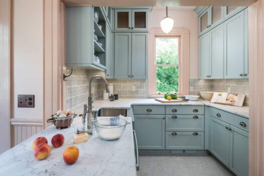 Victorian Inspired Kitchen Portland Victorian kitchen remodel with blue-green cabinets, tile backsplash, honed carrara marble countertops and farmhouse sink.