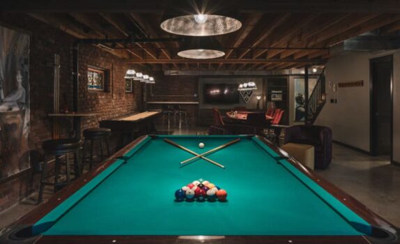 Above: Basement man cave with pool table and exposed brick wall Basement man cave with pool table and exposed brick wall