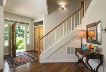 Remodeled Portland home entry way with staircase and oak planks