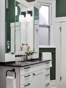 Small Transitional Bath in Northwest Portland, featuring two mirrored cabinets to make the space appear larger.