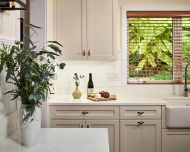 New England inspired kitchen remodel with natural light coming in through a nearby window.