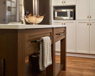 New England inspired kitchen remodel featuring elegant wood kitchen island.