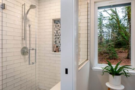 The primary bath features a vanity, private toliet room, and an expansive walk-in shower.