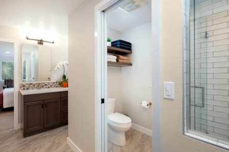 The primary bath features a vanity, private toliet room, and an expansive walk-in shower.