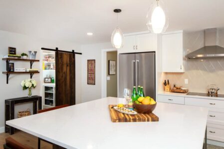 A reverse angle of the kitchen shows more of the island and the pantry in the background.