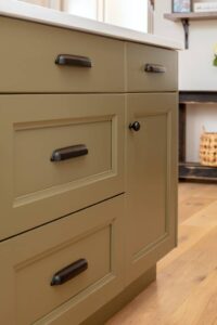 This detail of the kitchen island shows abundant cabinet storage and custom drawer pulls.