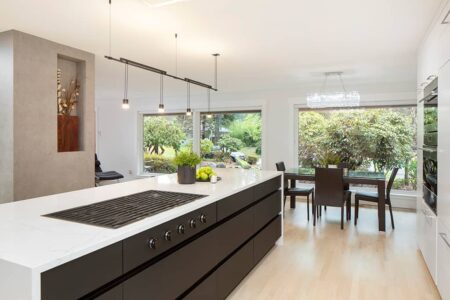 The kitchen island features abundant pullout storage close to the range.