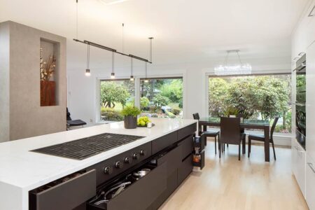 The kitchen island features abundant pullout storage close to the range.