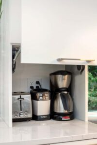 Small appliances are easy to reach but parked in a little side cabinet with a lift up door.