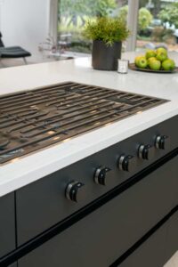 The kitchen island includes a built in range.