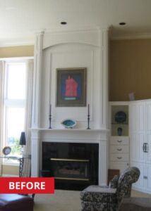 Living room with a black fireplace and white mantle from floor to ceiling.