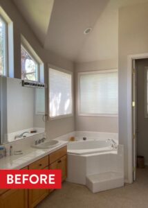 White bathtub tucked in the corner of a bathroom.