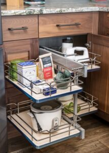 Slide-out kitchen drawers with snacks and kitchen appliances stored.
