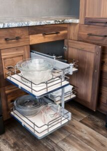 Slide-out kitchen drawers with snacks and glass cookware stored.