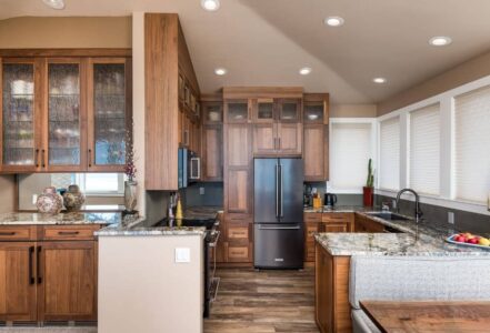 Kitchen with granite countertops and walnut cabinets with a unique modern door style.