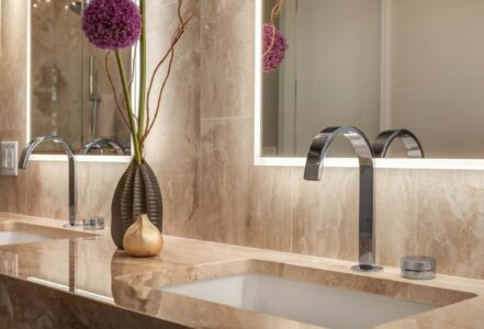 Fluerco Edge Lit vanity mirrors above a double vanity with chrome sinks.