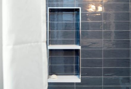 Bathroom shower with blue subway tiles.