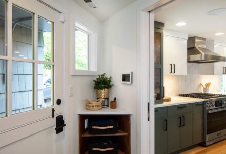 Corner shelf with two shelves built to the right of a door.