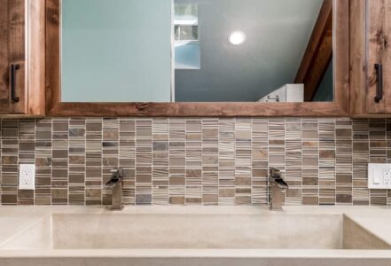Double vanity with long ramp-style sink integrated into concrete from Cement Elegance.