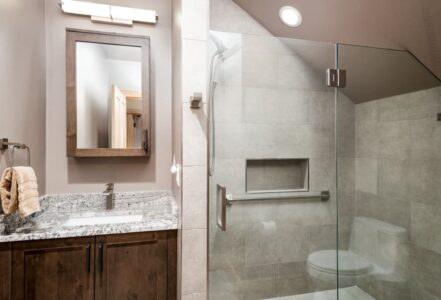 Walk-in shower with a grab bar.