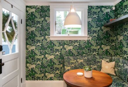Dining nook with a round wooden table.