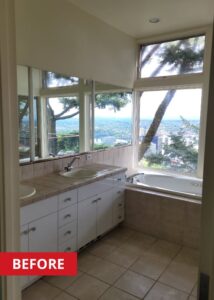 Bathroom double vanity with three mirrors on the wall above.