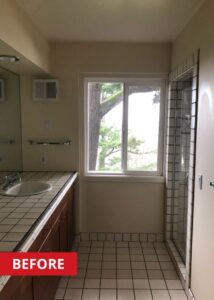 Old bathroom with a double vanity and walk-in shower.