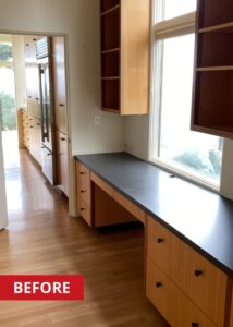 Workspace countertop with a black counter and brown kitchen drawers.