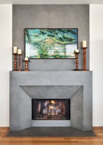 Concrete fireplace and wall-to-ceiling mantle from Cement Elegance in the living room.