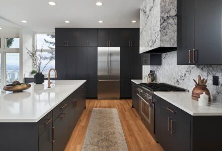 PentalQuartz kitchen counters, backsplash, and matching range hood that extends to the ceiling