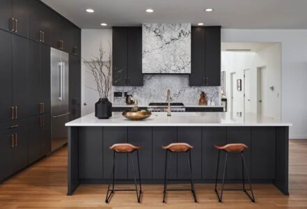 Modern kitchen bar with PentalQuartz kitchen counters and three bar stools.
