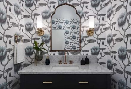 Remodeled powder room with patterned Cole & Son wallpaper.
