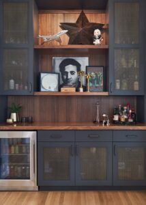 Kitchen bar space with wooden countertops and dark cabinets.