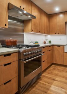 Thermador range with stainless steel backsplash and hood.