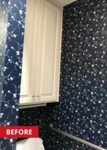 White cabinet above a toilet in a bathroom.