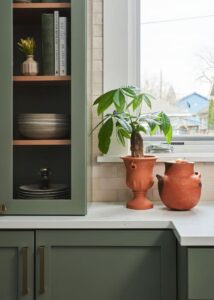 Shaker cabinetry from Hayes Cabinets with green Farrow & Ball paint and brass Emtek hardware.