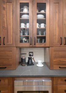 Walnut kitchen cabinets and drawers built around a kitchen counter.