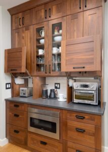 Walnut kitchen cabinets and drawers with a stay-lift appliance garage.