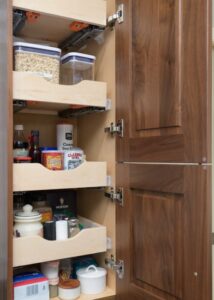 Walnut cabinet tower with pull-out drawer storage.