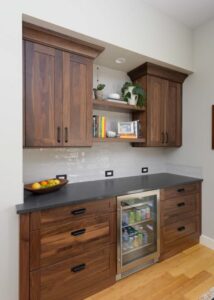 Walnut wall cabinets above a soapstone look-alike quartz countertop.