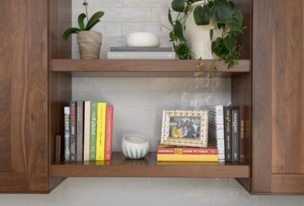 Walnut wall cabinets above a soapstone look-alike quartz countertop.