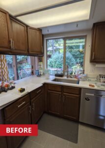 Kitchen with dark walnut cabinetry and a panel overhead light.